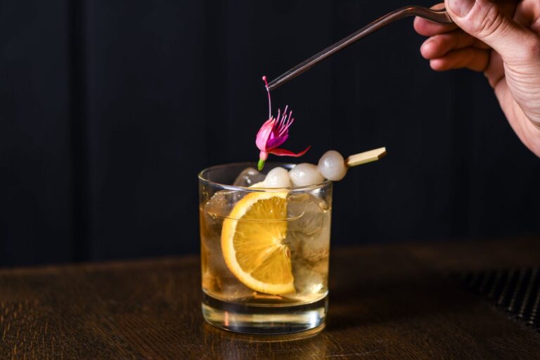 whisky with cocktail onions and edible flower